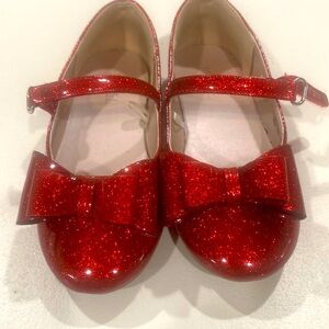 Shiney red Mary janes with a bow